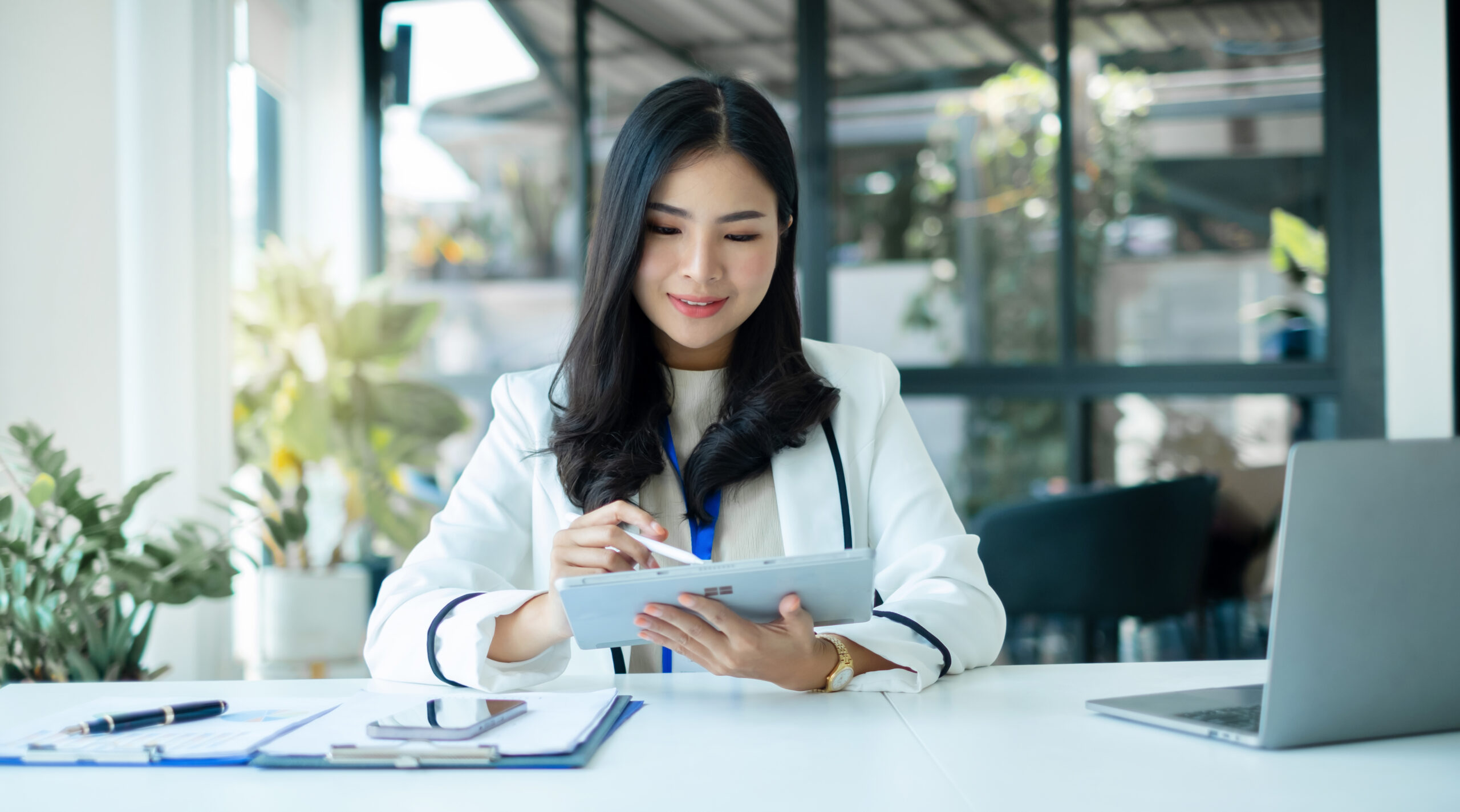 businesswomen sit at their desks and calculate financial graphs showing results about their investments, planning successful business growth processes in the office.
